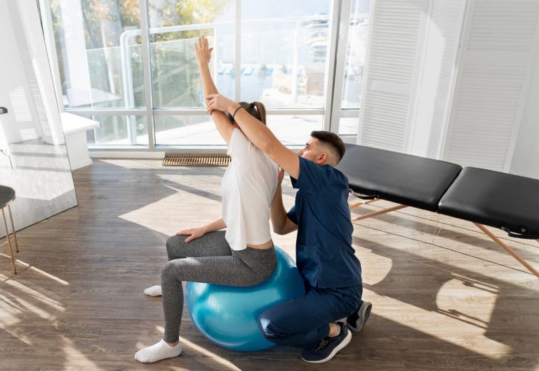 Pilates como tratamento: mulher praticando com ajuda de um terapêuta.