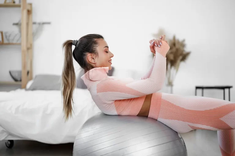 Aluna praticando pilates para dor lombar no Cadillac, focando em alongamento axial e controle abdominal.